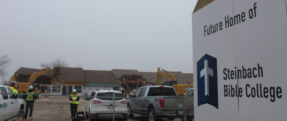 GREG VANDERMEULEN THE CARILLON
A small group of Steinbach Bible College staff gathered at their new Loewen Boulevard home on Monday morning to watch crews tear apart some of the former Steinbach Family Medical building.