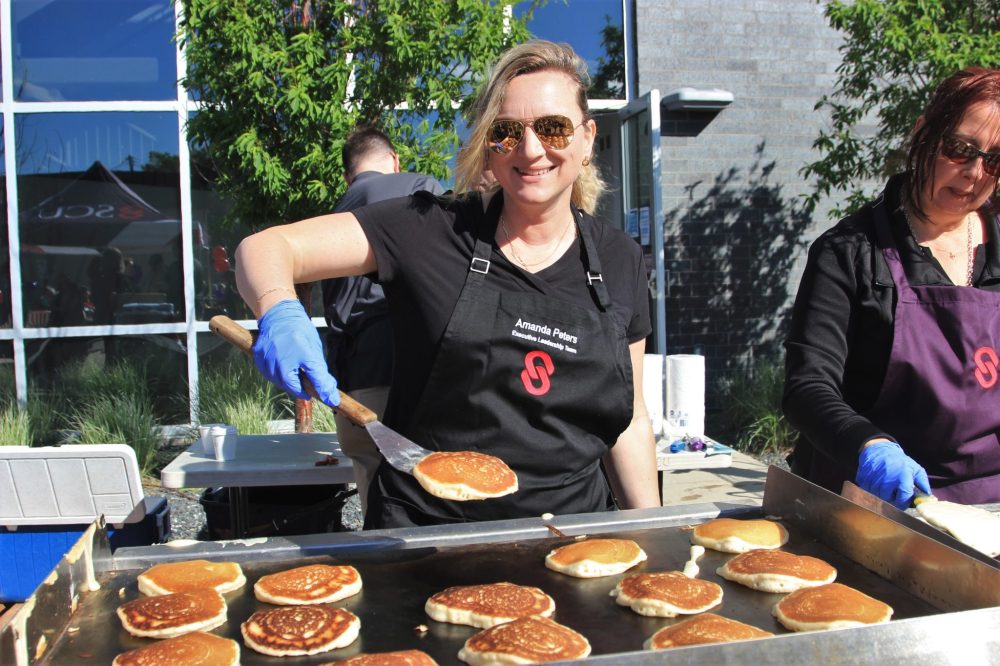 NICOLE BUFFIE CARILLON ARCHIVES
A volunteer serves up pancakes at the Summer in the City festival in 2022.