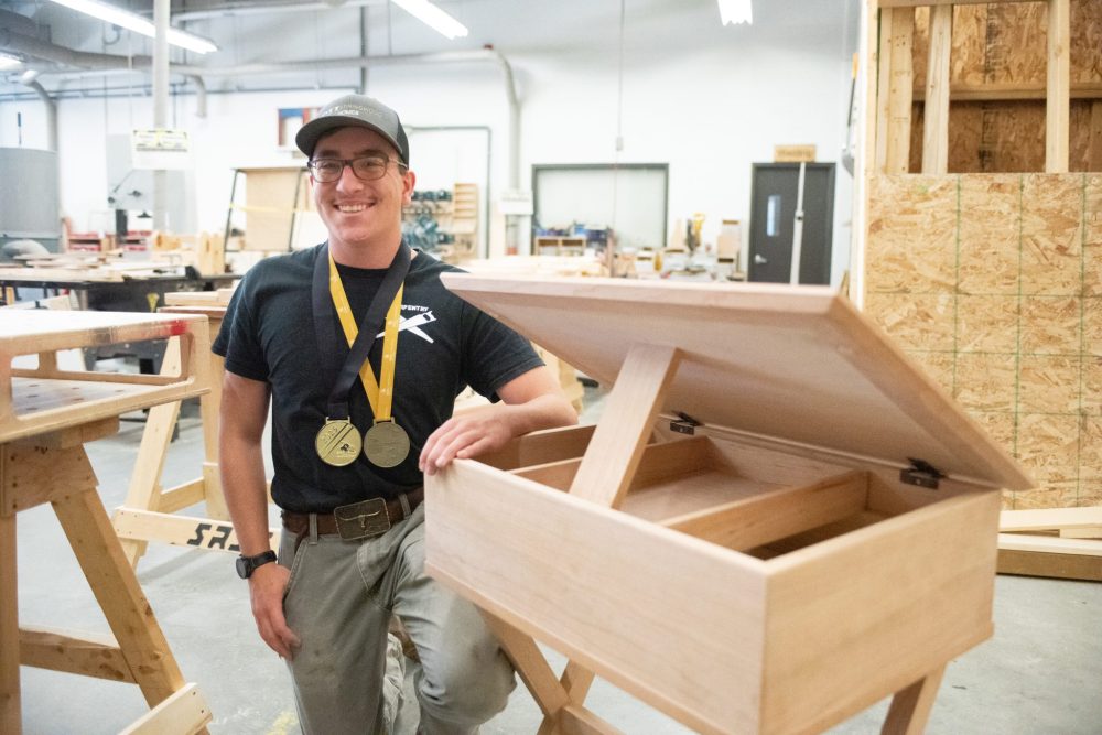SVJETLANA MLINAREVIC THE CARILLON
Steinbach Regional Secondary School student Connor Brick won Gold in the provincial and national legs of Skills Canada competition, which sees high school students from across the province and country compete in the trades. Here he is with the table he built to win Gold at nationals.
