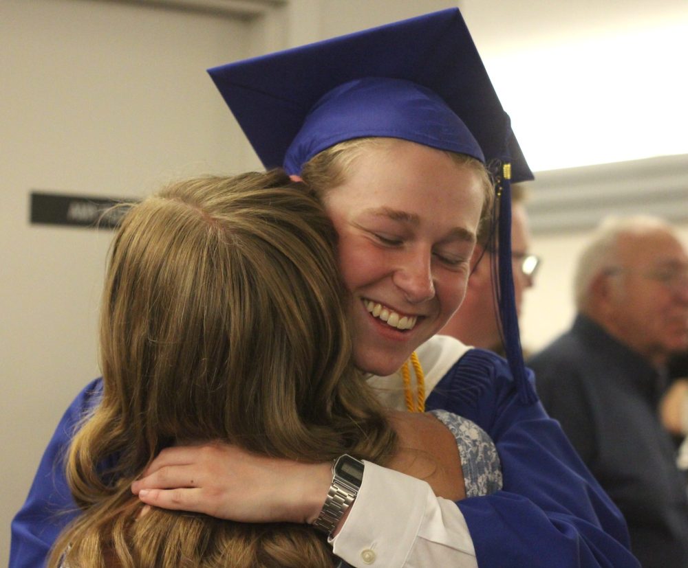 TONI DE GUZMAN THE CARILLON
Brendon Thiessen hugs a family member after receiving his diploma.