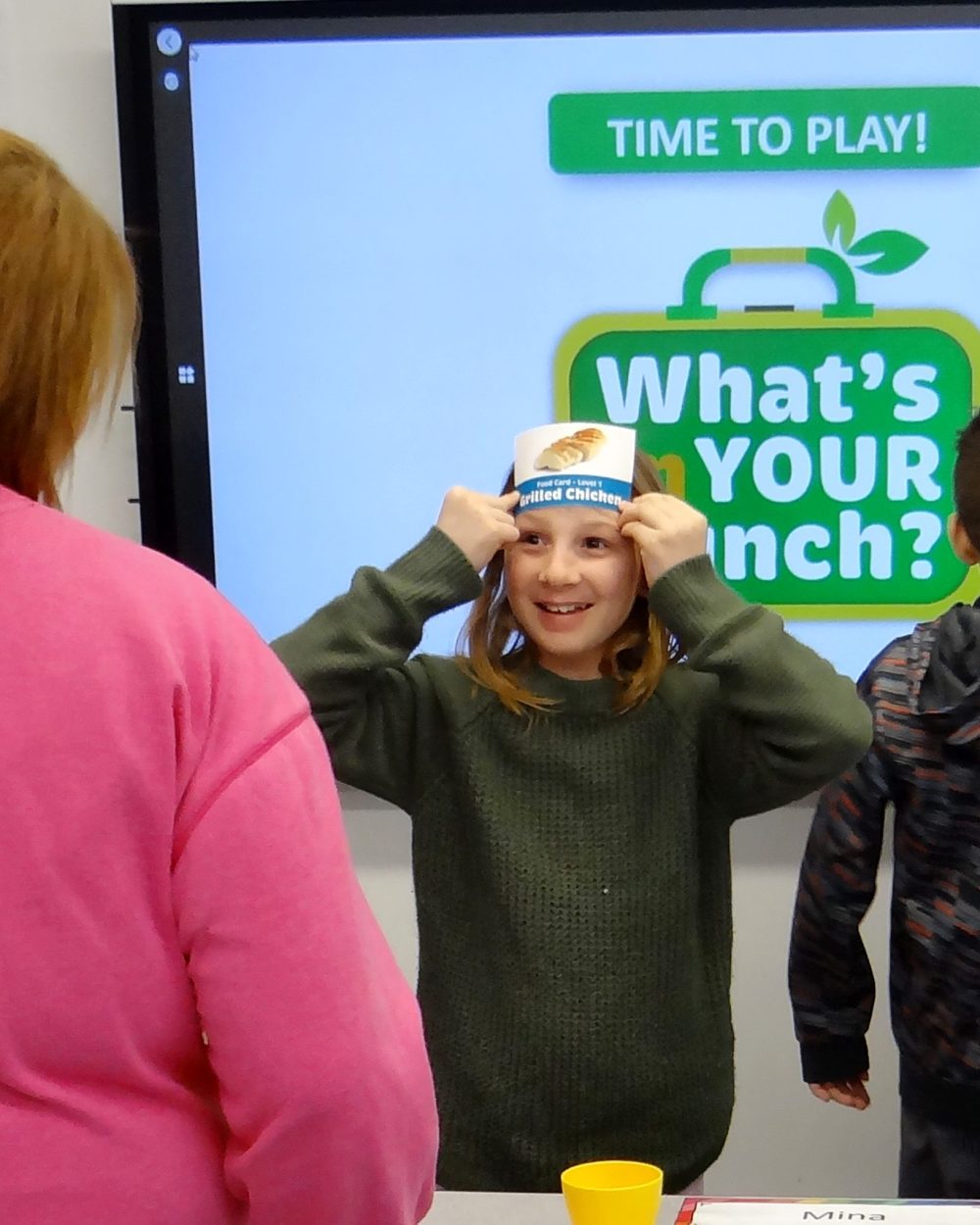 WES KEATING THE CARILLON
A student plays the food guessing game with her teacher, Melissa Goulet, at Ross L. Gray School.