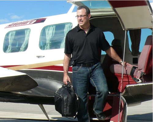 CARILLON ARCHIVES 

HyLife general manager Guy Baudry gets off the plane in Steinbach, after he and five other employees end their working day in Neepawa.