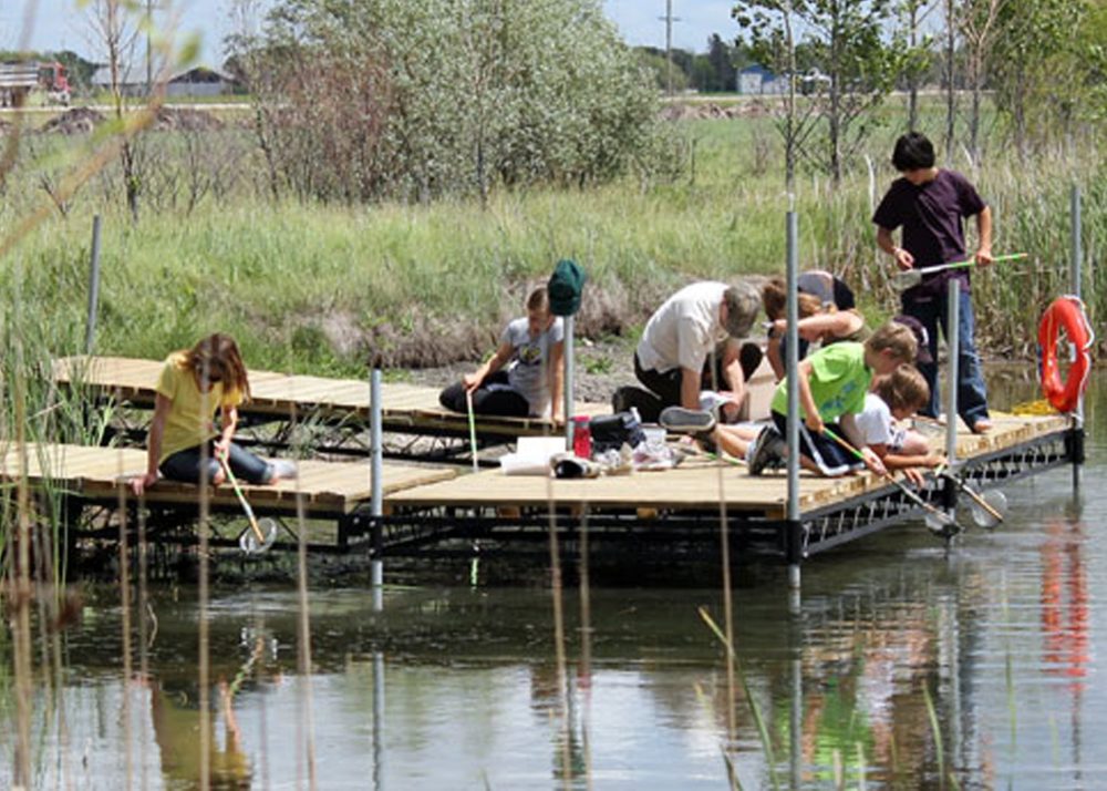 SRRWD
A group of young students enjoy “critter dipping”, catching water bugs from a stationary dock in the shallow pond at TCDC.