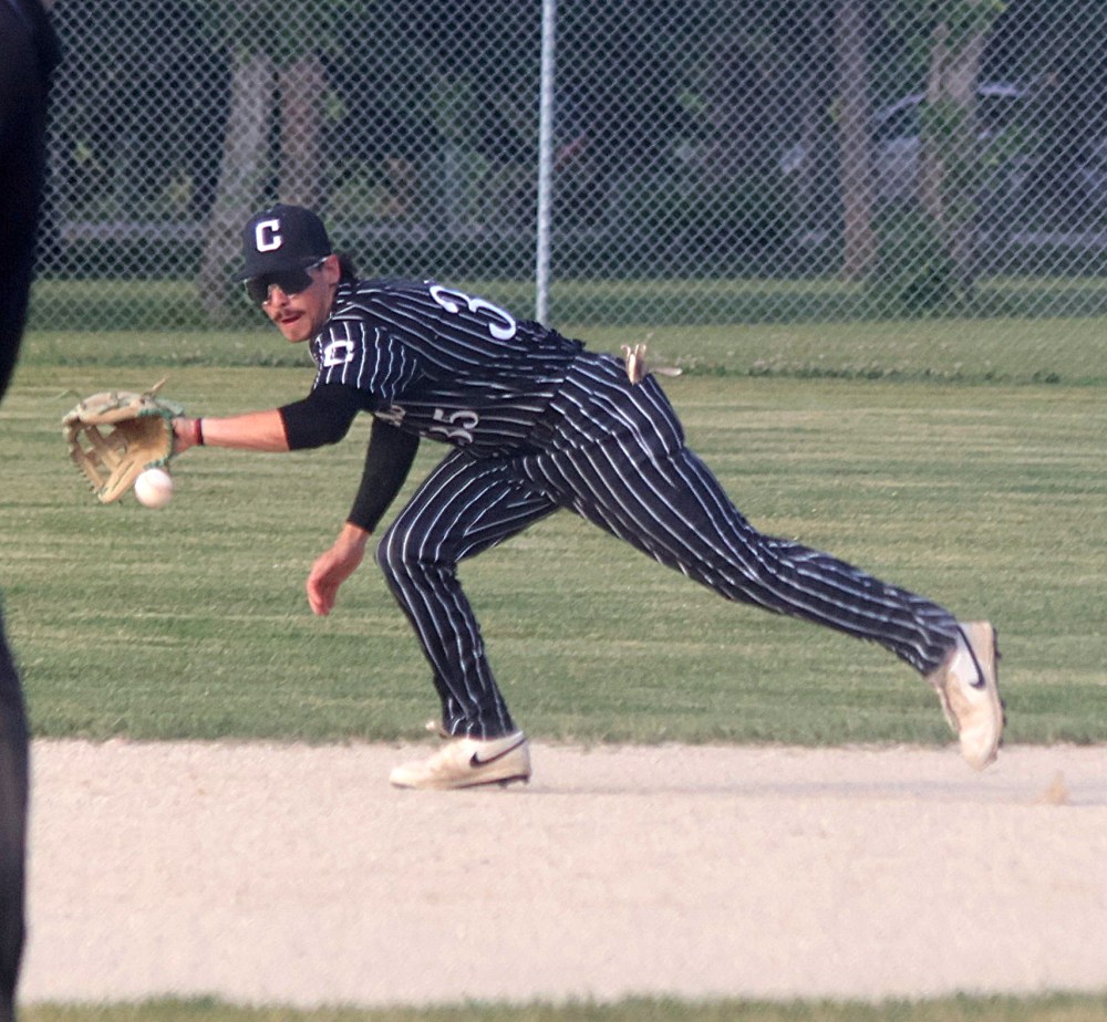 Cody Wielgosh picks up a ball at second base. (Cassidy Dankochik The Carillon)