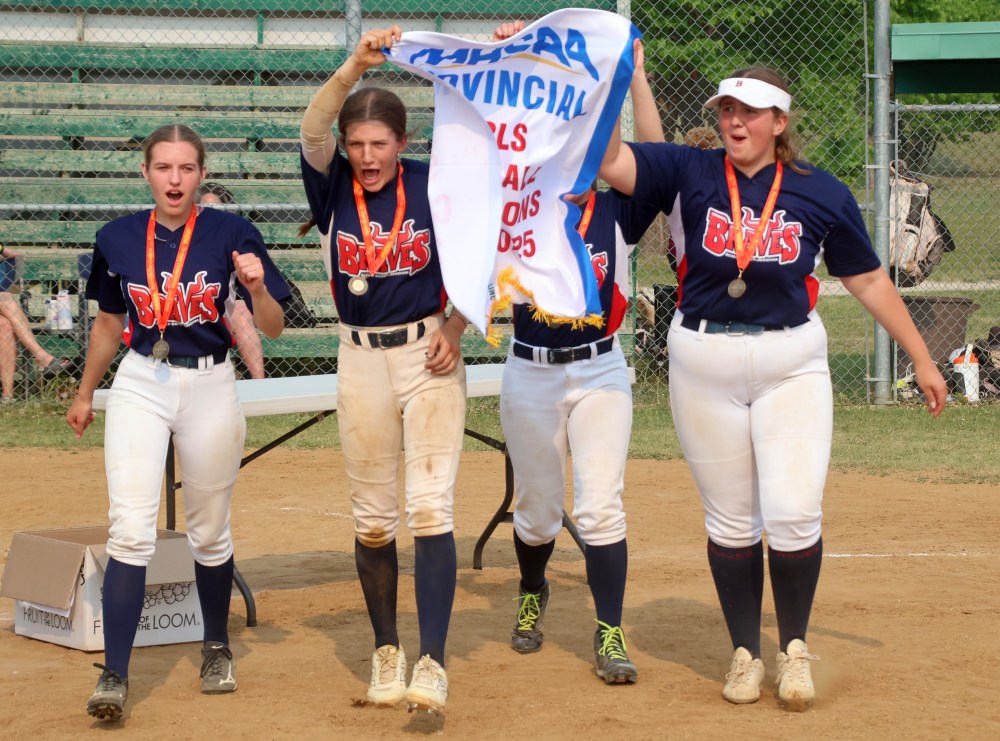 Graduating Saint-Joachim/Real Berard players celebrate as they bring the provincial banner back to their teammates. (Cassidy Dankochik The Carillon)