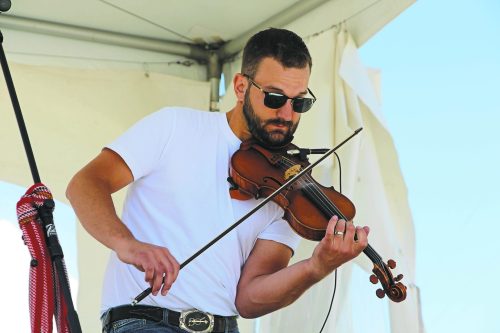 ALEX LAMBERT THE CARILLON ARCHIVES 

New to Artists in the City are young fiddlers who will showcase their talents. Here fiddler Nic Messner plays his violin at Summer in the City on June 16, 2024, in front of an energetic Artists in the City crowd.