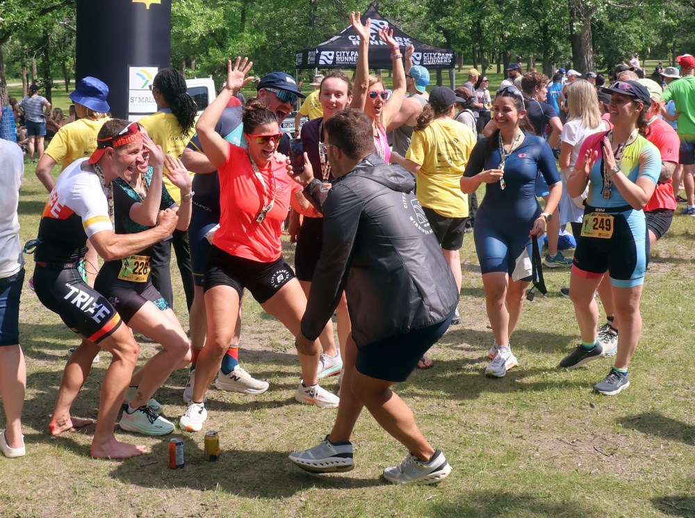 A group of happy finishers celebrate while recording a video at the finish line of the St Malo Triathlon June 21. (Cassidy Dankochik The Carillon)
