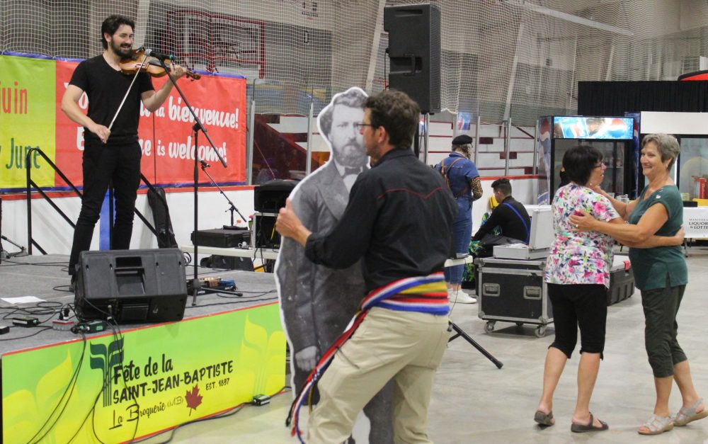 CHRIS GAREAU THE CARILLON
Louis Riel takes a spin with Rice Turenne to the tunes played by Michael Audette at Fête de la Saint-Jean-Baptiste in La Broquerie Sunday. Turenne is executive director of the Union nationale métisse Saint-Joseph du Manitoba, which dates back to 1887. It is making a point of being present at more Métis and francophone events in the Southeast this year.