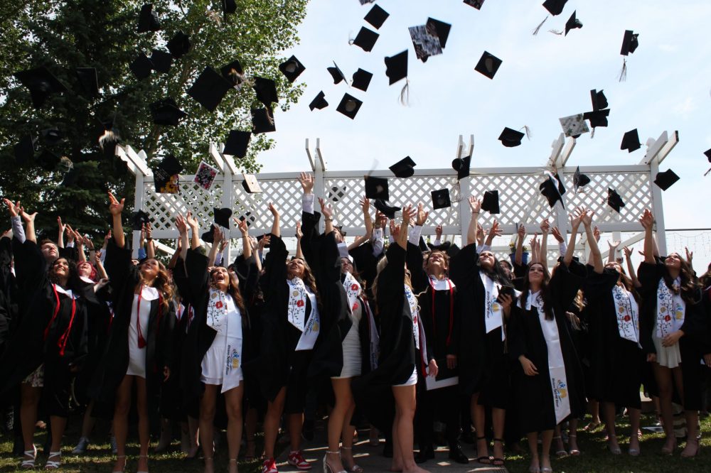TONI DE GUZMAN THE CARILLON
Collège Lorette Collegiate graduates throw their caps in the air on June 26.