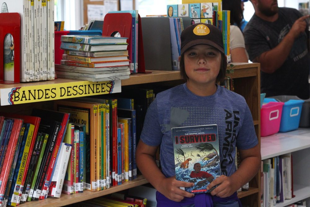 TONI DE GUZMAN THE CARILLON
Emika Gagner, 10, shows one of their favourite books, and is one of the first people to visit the library on Tuesday.