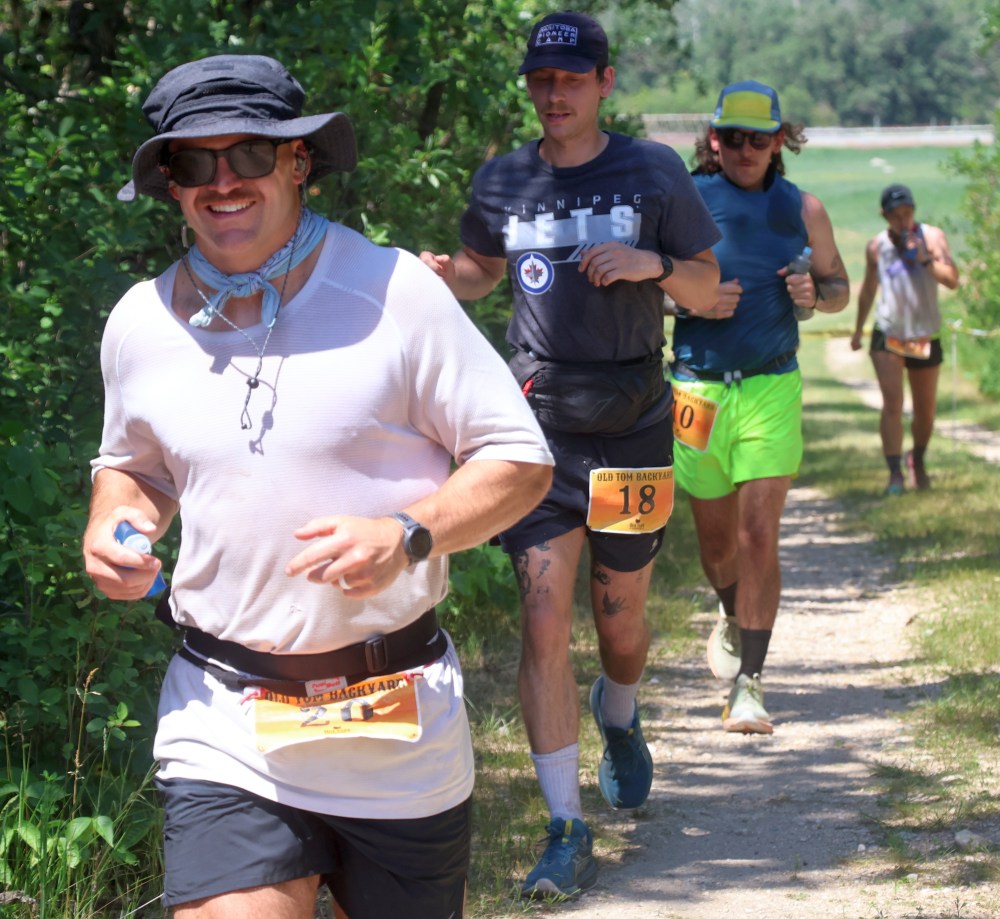 Runners brave a smile during lap seven of the Old Tom Backyard Ultramarathon July 5. (Cassidy Dankochik The Carillon)