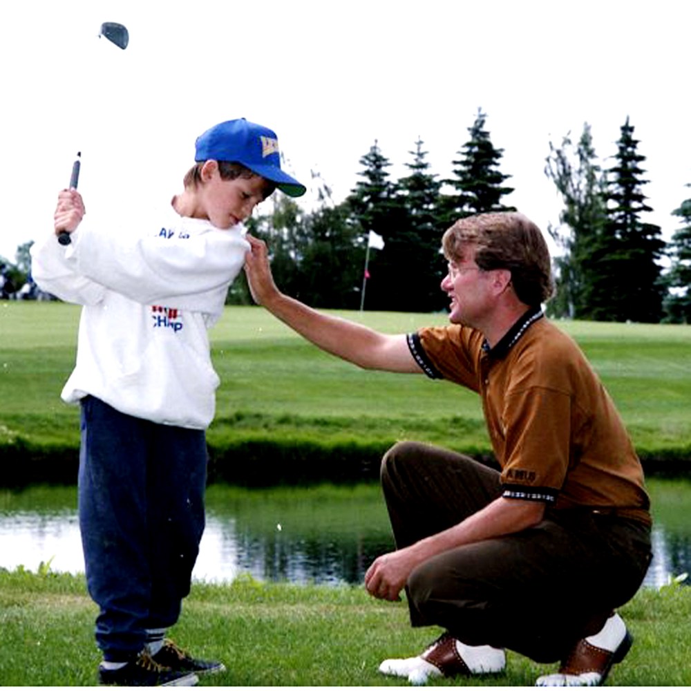 Steinbach golf pro Larry Robinson gives David Morin some last minute instructions before the 10-year-old attempts to clear the water hazard in front of the 18th green at the Steinbach Fly-In Golf Course. (Carillon Archives)