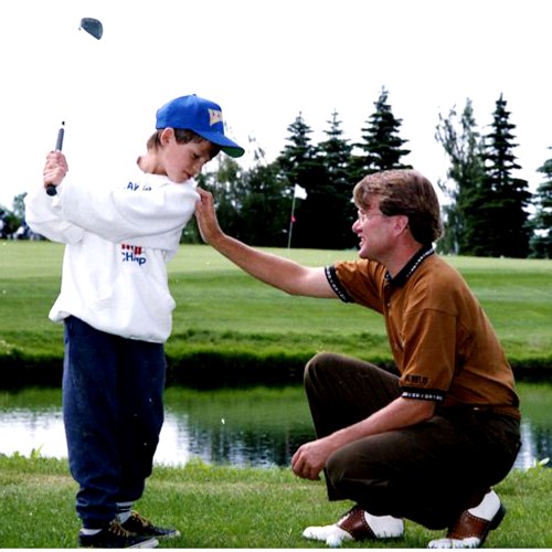 Steinbach golf pro Larry Robinson gives David Morin some last minute instructions before the 10-year-old attempts to clear the water hazard in front of the 18th green at the Steinbach Fly-In Golf Course. (Carillon Archives)