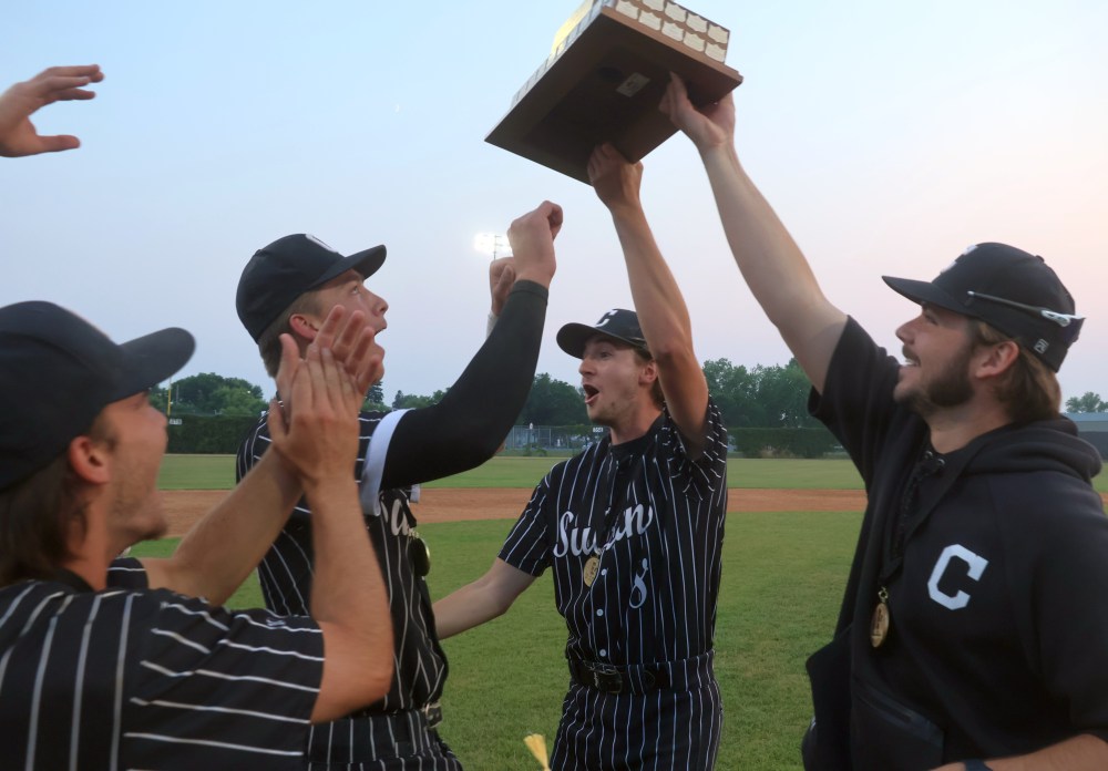 Graduating Sultans players Rylan Penner and Tyler Plett return with the championship trophy to their teammates. (Cassidy Dankochik The Carillon)