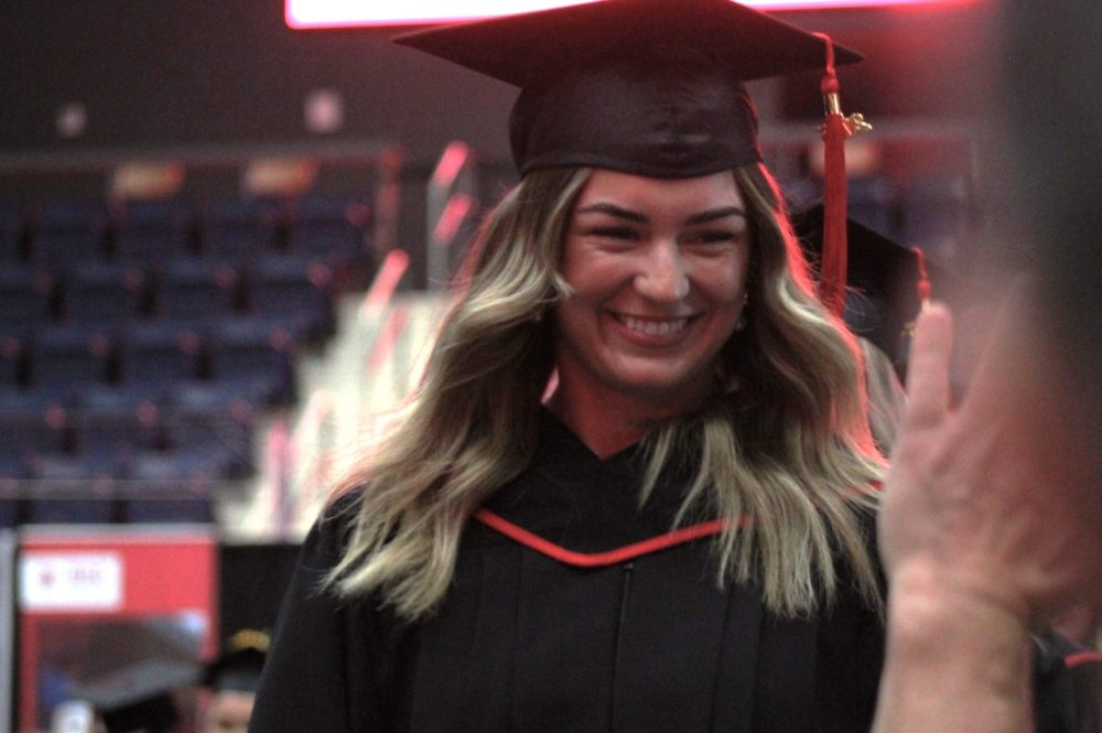 CHRISTIAN JADE SICAT THE CARILLON
CHRISTIAN JADE SICAT THE CARILLON
A graduate flashes a big smile at a supporter.