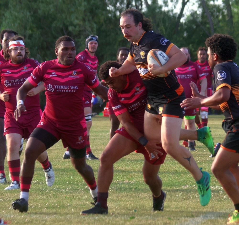 A Manitoba Wombats player is tackled during rugby action at A.D. Penner Park June 26. (Cassidy Dankochik The Carillon)