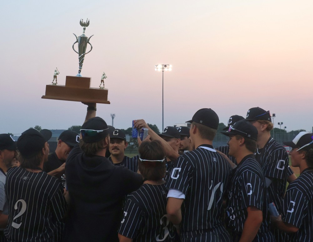 Carillon celebrates with the championship trophy in the setting sun at Koskie Field in Winnipeg. (Cassidy Dankochik The Carillon)