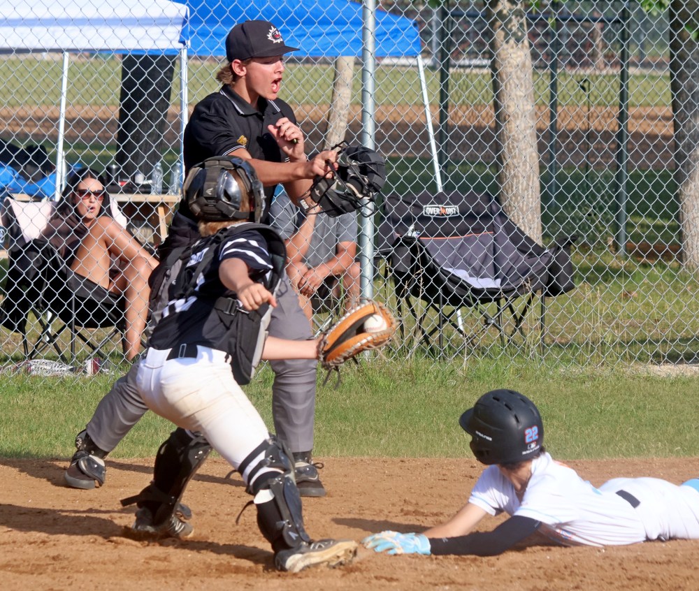 The umpire during a U13 AAA baseball game in Ile des Chenes July 27 between the Carillon Sultans and Brandon gives an emphatic out call at home plate. (Cassidy Dankochik The Carillon)