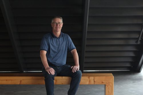 TONI DE GUZMAN THE CARILLON 

Russ Dyck sits at one of the benches made from the Centennial Arena’s fir wood rafters at the Southeast Event Centre.