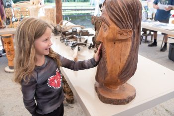 SVJETLANA MLINAREVIC THE CARILLON
Alexis Waldener of Woodridge enjoyed looking at the wood carvings on display for the town's 125th anniversary celebrations on July 26, 2025.