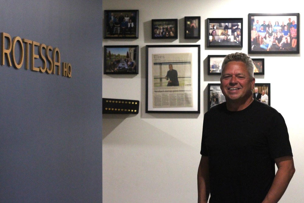 TONI DE GUZMAN THE CARILLON
Greg Lepp in front of a wall of memories filled with photos of the Rotessa team and their milestones at the main level in the office.