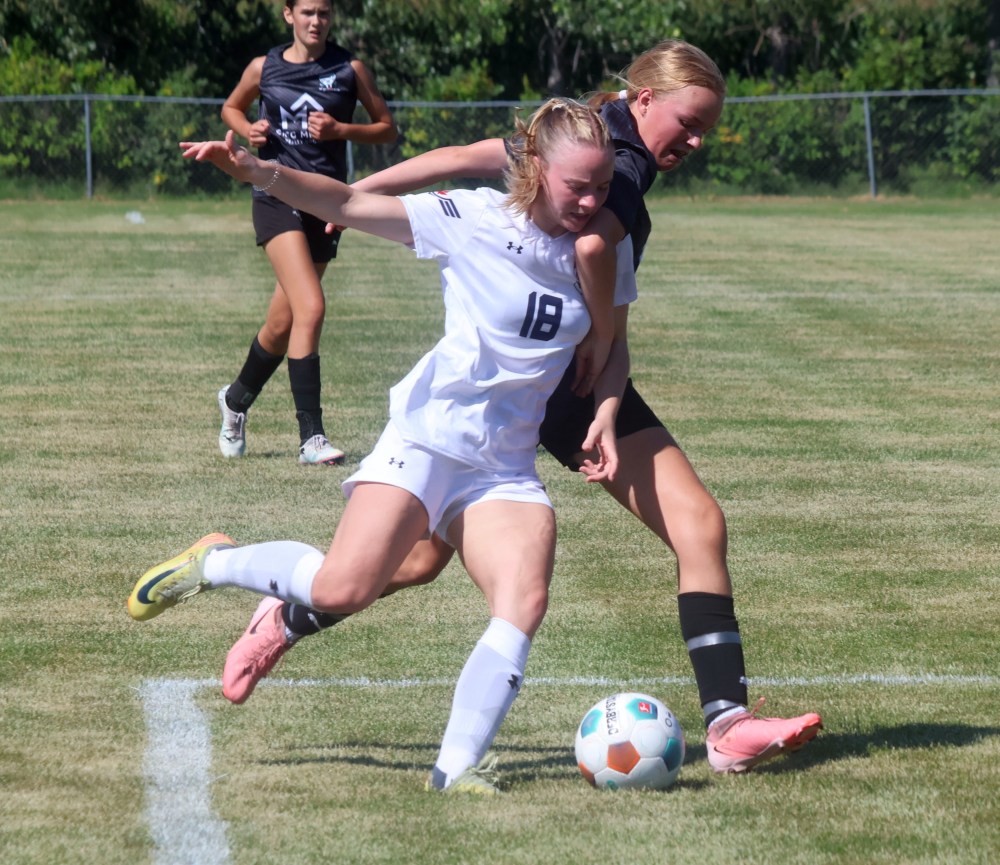 Jayda Codling battles with a Phoenix FC player during first half action of a Providence Pilots pre-season game Aug. 16. The Pilots have expanded their pre-season camp this year for soccer, scheduling eight pre-season games across Western Canada. (Cassidy Dankochik The Carillon)