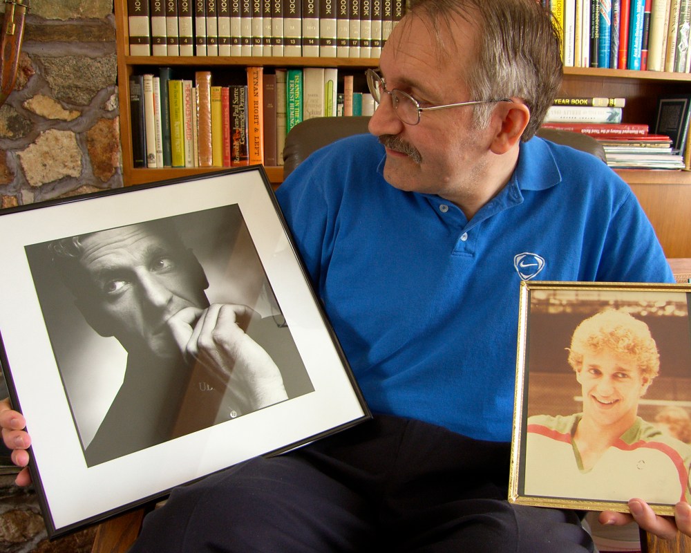 Glowing with family pride for Ralph Krueger’s success as coach of the Swiss hockey team which just had defeated Canada in the Olympics, Stefan Krueger displays pictures of his brother as a coach and motivational speaker and as a teenaged hockey player. (Carillon Archives)