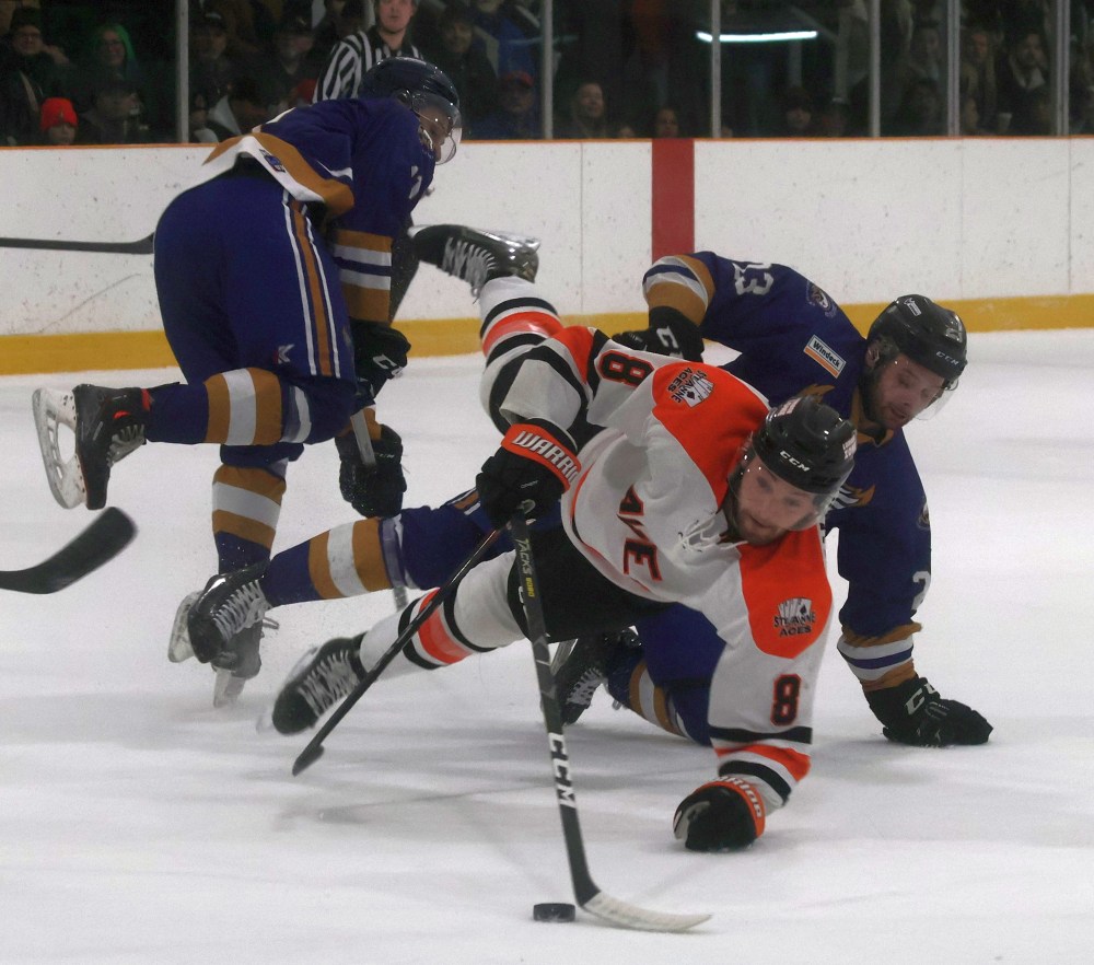 Caleb Paisley reaches for the puck during game seven of the 2025 SEMHL finals. (Cassidy Dankochik The Carillon)