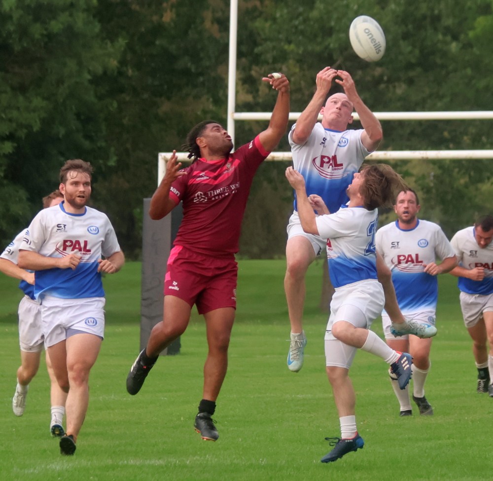A pair of players duel in the air for the ball during a rugby match at A.D. Penner Park Aug. 14. (Cassidy Dankochik The Carillon)