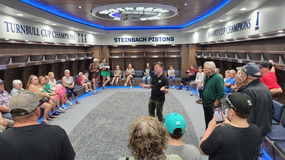 Pistons director of business operations Kevin Geisheimer leads a tour of the Steinbach Pistons new locker room for attendees at the Southeast Event Centre's grand opening Aug. 21. (Cassidy Dankochik The Carillon)