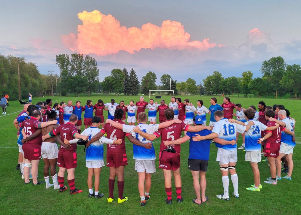 The Winnipeg Assassins and Eastman Warriors gather together for a post-game circle after the end of their match Aug. 14. (Cassidy Dankochik The Carillon)