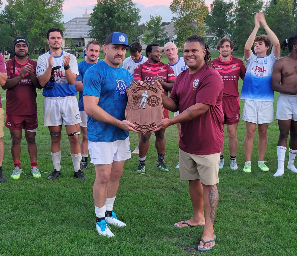 The Assassins accept the Spirit Shield, a trophy created by the Eastman Warriors to celebrate the two team's friendly rivalry in Manitoba Rugby's Premier Division. (Cassidy Dankochik The Carillon)