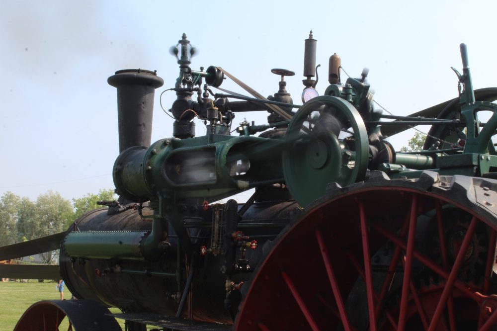 MATTHEW FRANK THE CARILLON
The steam engine's piston and wheel spinning as it powers the threshing machine.