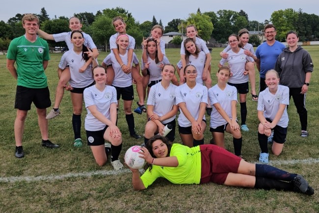 SUPPLIED
Back left: Asst. Coach Noah Froese, Ava Yuill, Myckenna Plett, Maggie Kennedy, Skyla Brule, Selah Barkman, Asst. Coach Cam Plett, Head Coach Dillon Plett. Middle: Anya Dydo, Alyvia Penner, Ayla Trotta, Isabella Unrau, Kari Born. Front: Madeline Moesker, June Barkman, Neveaha Lariviere-Montrose, Olivia Yuill, Brooklyn Goertzen. Goalie: Leah Swenarchuk. Missing from photo: Emirsyn Friesen.