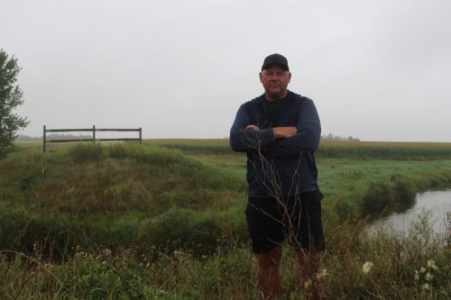 MATTHEW FRANK THE CARILLON 

Farmer Arthur Rempel stands by Manning Canal that divides his corn fields and where the bridge previously was built on Sept. 2. Before it burned, the bridge made accessing his fields more convenient, Rempel said.