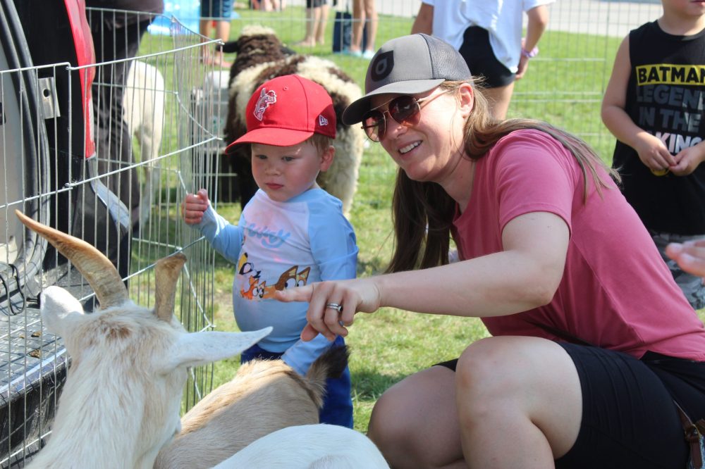 MATTHEW FRANK THE CARILLON
Alisha From and her one-year-old son Carson pet goats at Le St Malo Street Bash's petting zoo.