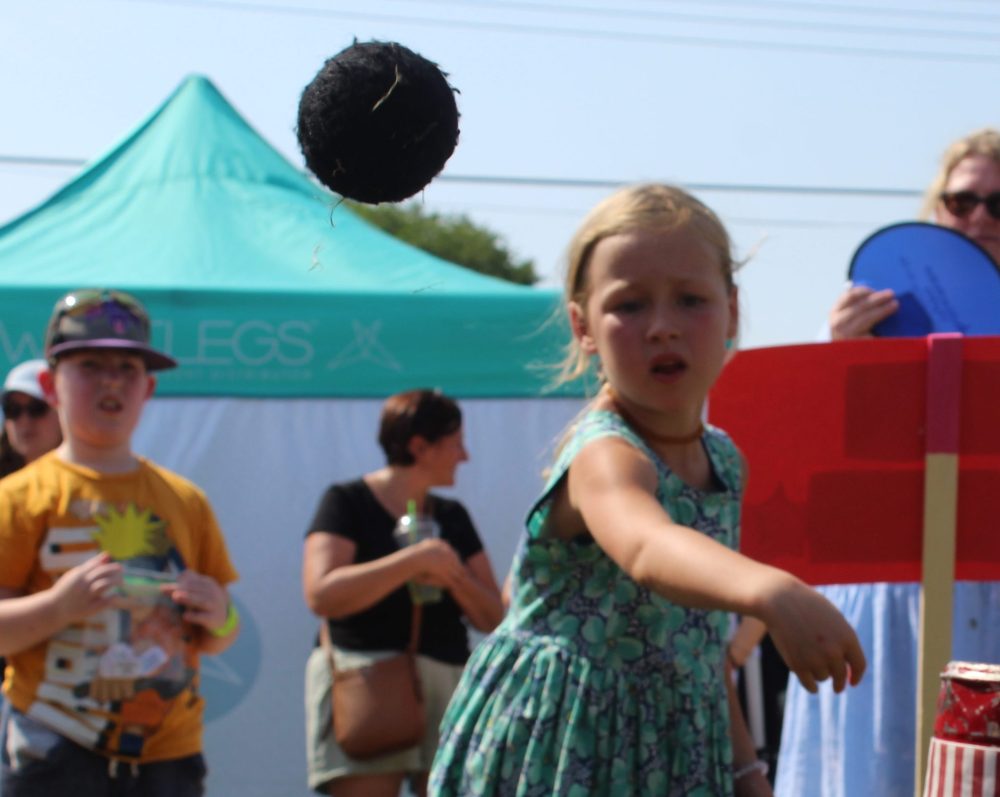 MATTHEW FRANK THE CARILLON
Six-year-old Emerson Cadieux tries to knock down tin cans for a prize at Le St Malo Street Bash.