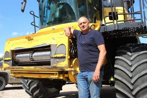 MATTHEW FRANK THE CARILLON 

Mike Reimer, a farmer north of Steinbach, stands with a combine before he checks his canola fields on Monay. He labeled the federal tariff support for farmers as “Band-Aid” solutions.