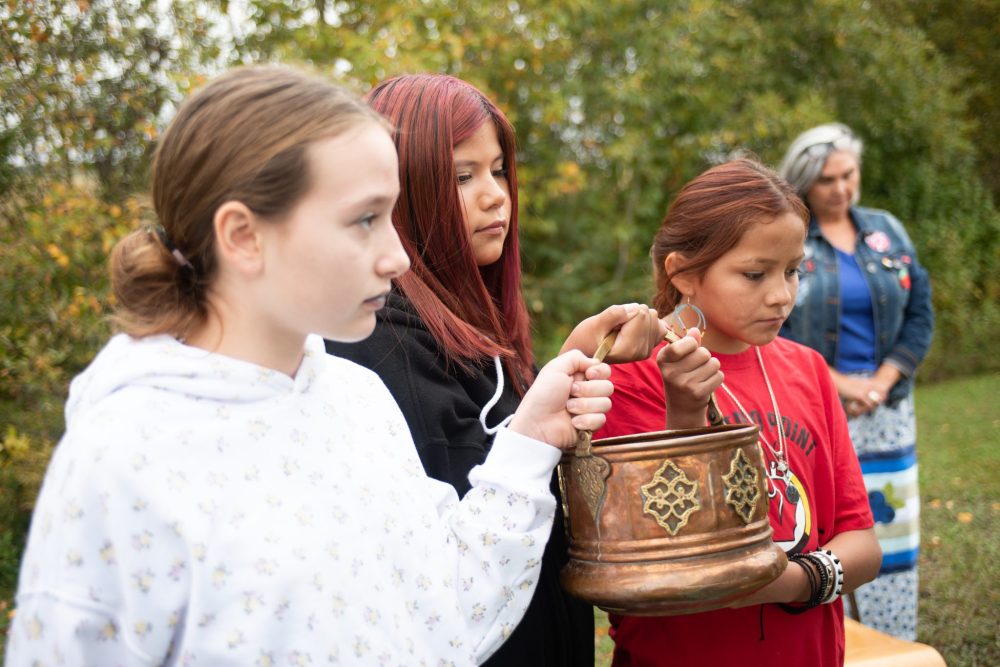 SVJETLANA MLINAREVIC THE CARILLON
Sprague and District Historical Museum opened the doors to its newest exhibit the Indigenous Building on Sept. 20, 2025. After the water ceremony, a pail of water was blessed which was held by (left to right) Bentleigh Keffer, Adrianna Richard, and Angel Richard. Cups of the blessed water were handed out to attendees to drink.