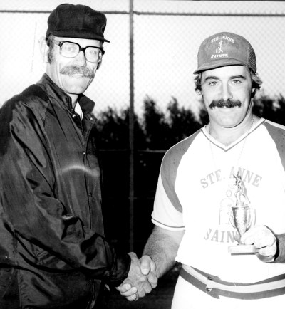 Peter Dick of the Steinbach Umpires’ Association presents the MVP trophy to Jacques St Vincent of the Ste Anne Saints.