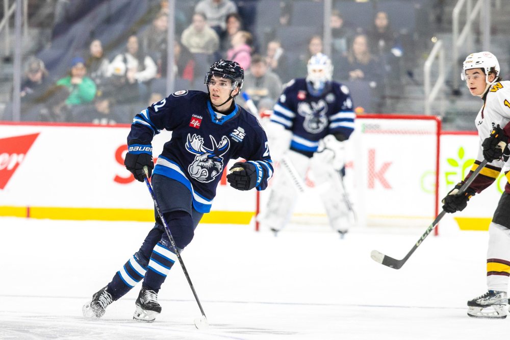 MIKAELA MACKENZIE / FREE PRESS
Manitoba Moose Mason Shaw goes over Chicago Wolf Charles-Alexis Legault as Gleb Trikozov watches in a school day game (with students from early years through high school watching) at the Canada Life Centre on Thursday, Nov. 21, 2024. The Moose will be in Steinbach Oct. 5 for their annual intrasquad game.