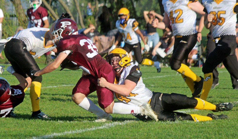 Grade 12 defensive line player Seth Friesen tackles a St Paul's running back during Winnipeg High School Football pre-season action at A.D. Penner Park Aug. 28. (Cassidy Dankochik The Carillon)