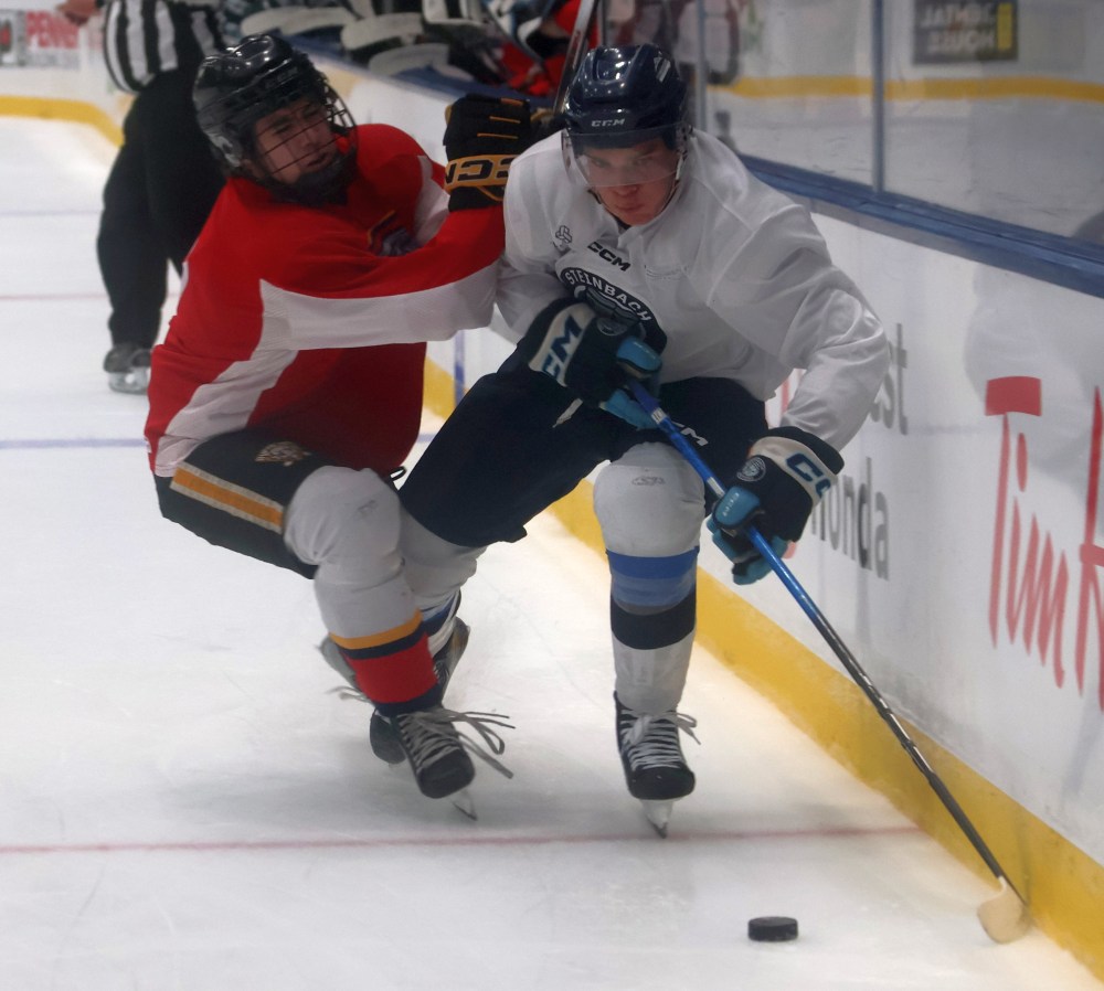 A Steinbach player squeezes past a Niverville player during the team's final pre-season game of the season Sept. 13. (Cassidy Dankochik The Carillon)