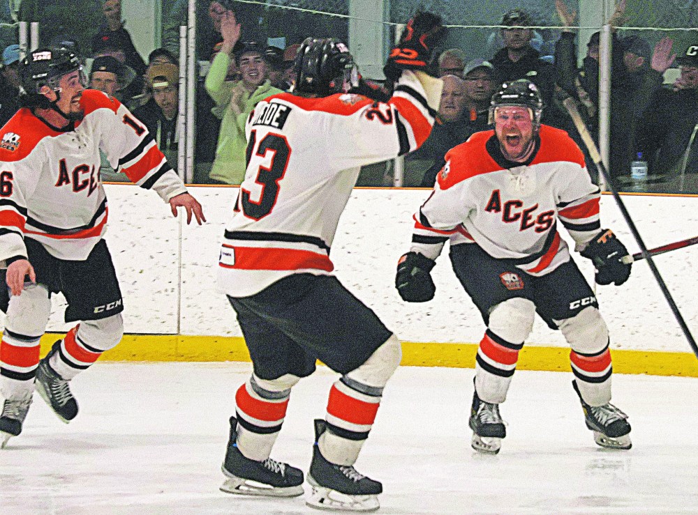Teammates rush to mob Cody Fowlie after his game seven overtime winner in the SEMHL finals. Fowlie's Ste Anne Aces overcame a 3-2 series deficit thanks to a Brenden Walker late equalizer and Fowlie's winner. Fowlie finished with three goals and an assist in the game seven victory. (Cassidy Dankochik The Carillon)