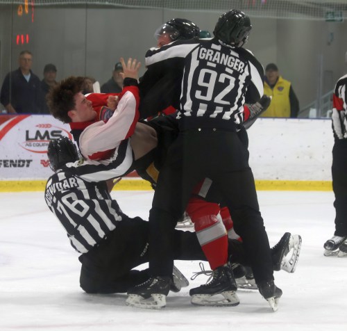 Linesmen Matt Granger and Deven Gowdar break up a fight between a Selkirk and Niverville player during their pre-season game. (Cassidy Dankochik The Carillon)