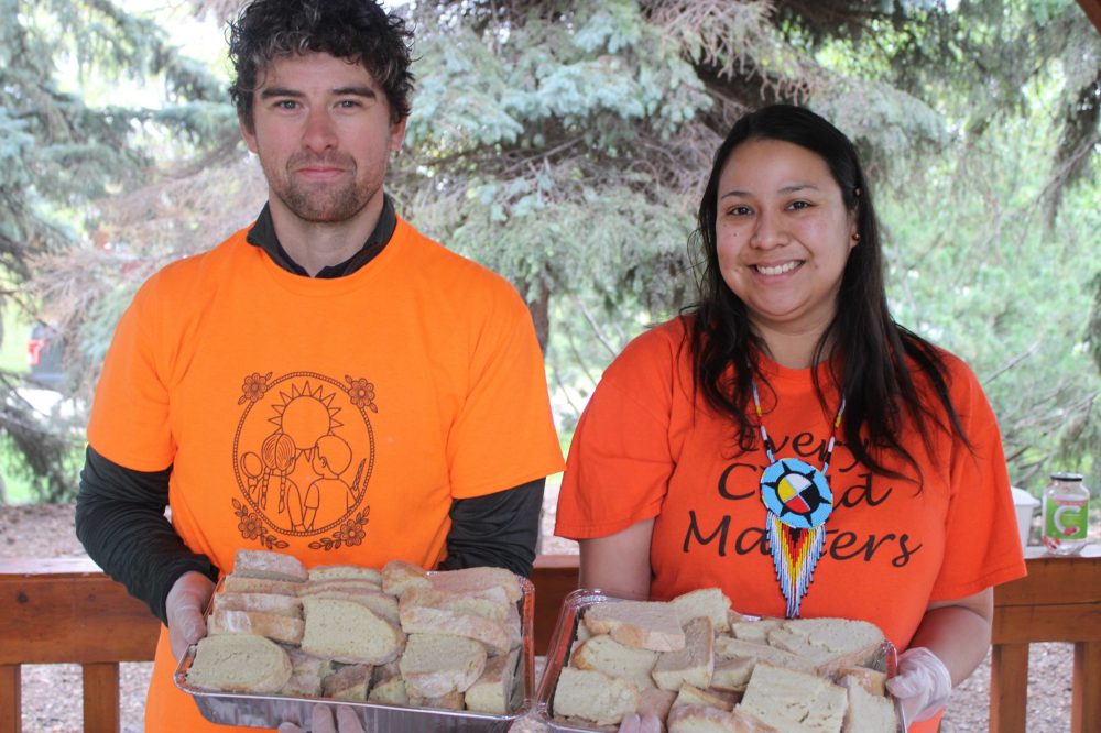 GREG VANDERMEULEN THE CARILLON
Devyn Bartel and Tahnee Hoff served bannock to the hungry participants who walked from the Southeast Event Centre to K.R. Barkman Park.
