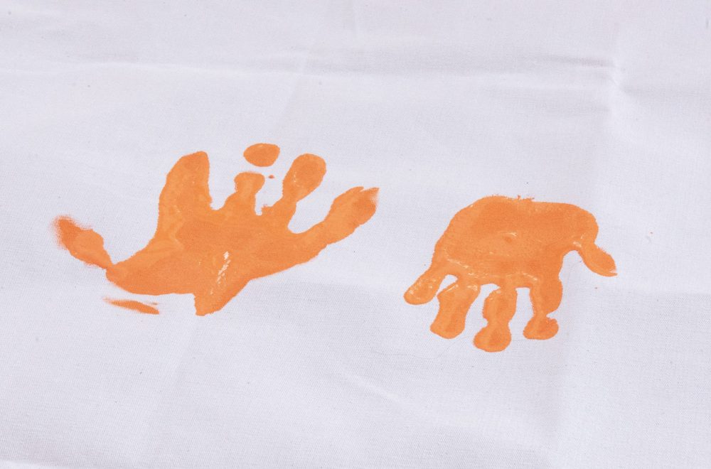 SVJETLANA MLINAREVIC THE CARILLON
Mino Odewin held its Orange Shirt Day Walk on Sept. 30, 2025. It's walk ended at the Steinbach Arts Centre where Mino Odewin asked attendees to put their handprints onto the Every Child Matters banner. Here an adult handprint lays next to a child's handprint. The banner will be used for every walk going forward.