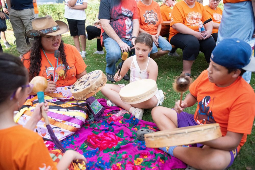 SVJETLANA MLINAREVIC THE CARILLON
Mino Odewin held its Orange Shirt Day Walk on Sept. 30, 2025. It's walk ended at the Steinbach Arts Centre where a drumming circle led by Rayne Ryle who taught the local youth. Learning to drum with Ryle (left) was Solomiia Khuma and Nev Cheages.