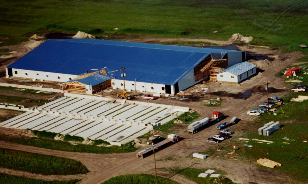 CARILLON ARCHIVES
In this aerial photo, semi-trailers next to the building at the Tritek Farms construction site look like toy trucks, indicating the massive size of the first of two Janzen/Vielfaure barns being built to house a 2,500 farrow-to-weanling hog operation.