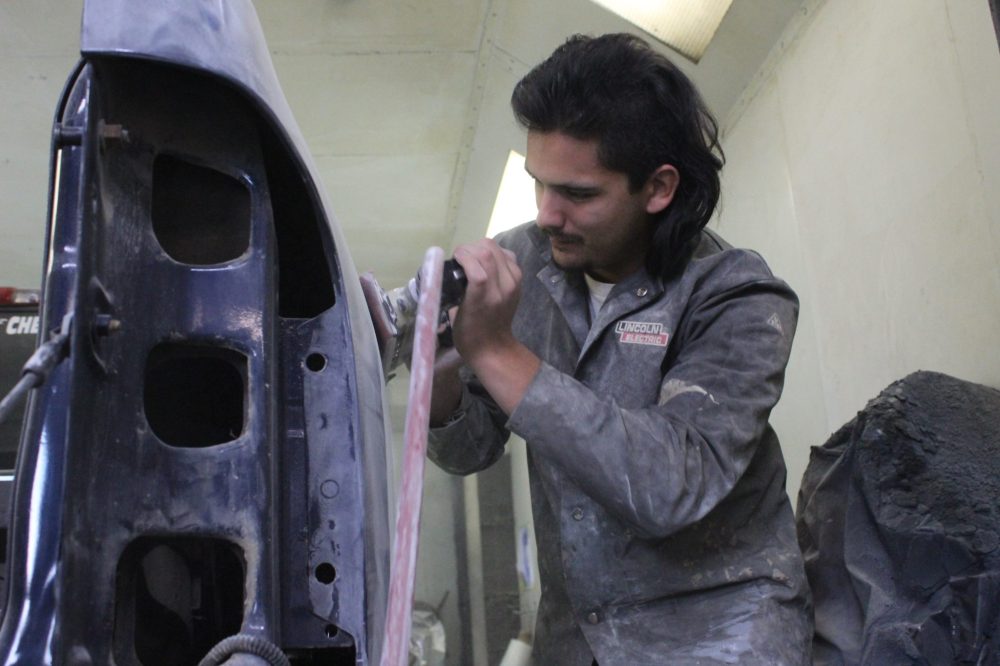 MATTHEW FRANK THE CARILLON 
Denis Gobeil, 23, sands a vehicle at Good N Tension Autobody in St Adolphe on Oct. 20. The Provincial Road 200 bridge closure could delay how quickly he would get parts for the shop, Gobeil said.